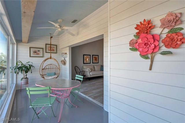 sunroom featuring vaulted ceiling with beams