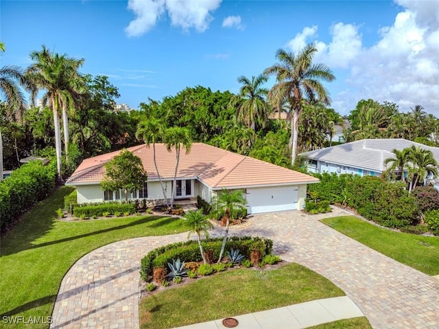 single story home with a front yard and a garage