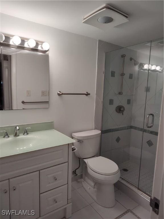 bathroom featuring vanity, toilet, and a shower with door