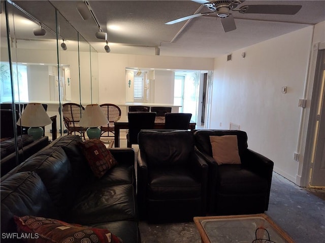 living room featuring ceiling fan and rail lighting