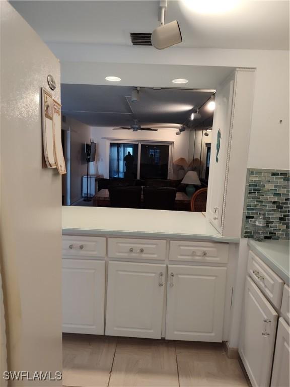 kitchen featuring white cabinetry and decorative backsplash