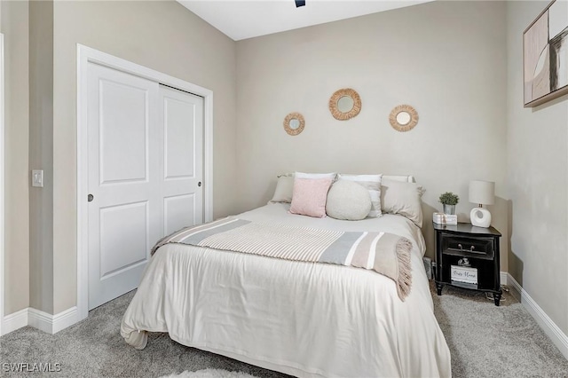 bedroom with light carpet and a closet