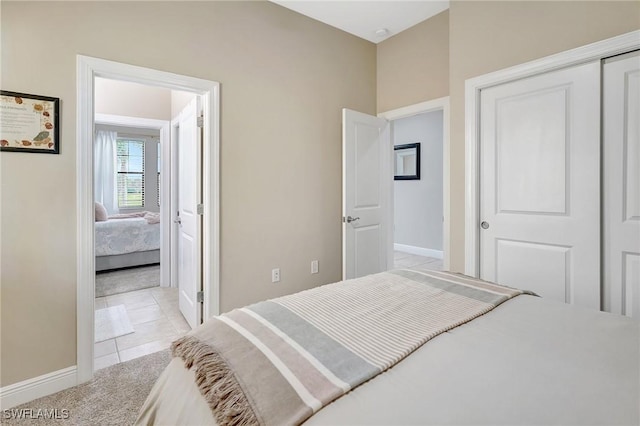 bedroom with light colored carpet and a closet