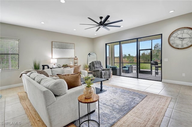 living room with ceiling fan and light tile patterned flooring