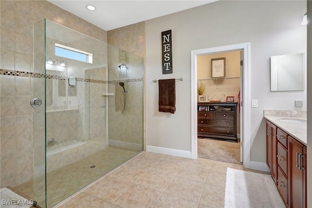 bathroom with vanity, tile patterned floors, and a tile shower