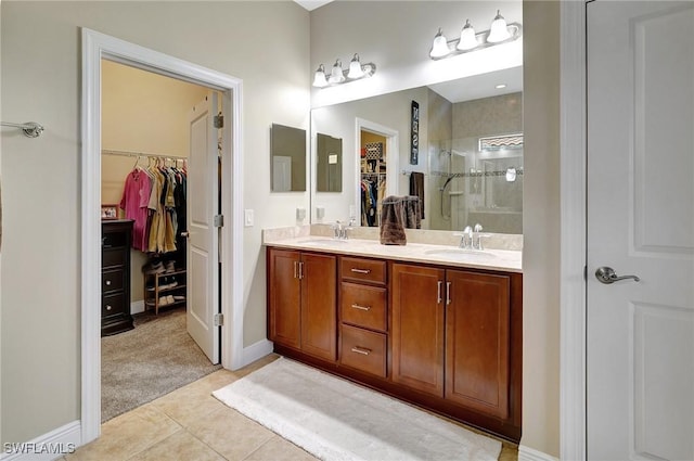 bathroom featuring walk in shower, tile patterned floors, and vanity