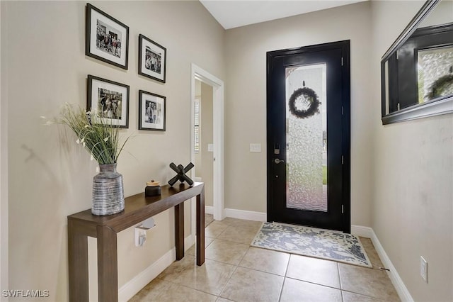 entrance foyer featuring light tile patterned floors and baseboards