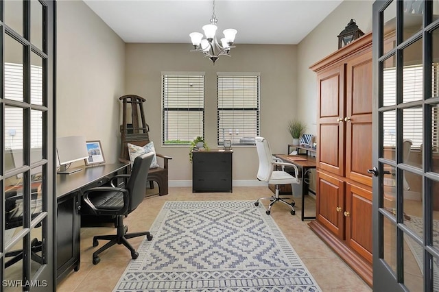 tiled home office featuring plenty of natural light and a chandelier