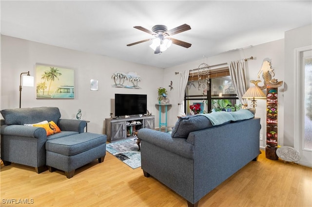 living room featuring hardwood / wood-style floors and ceiling fan