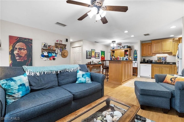 living room featuring light hardwood / wood-style floors and ceiling fan