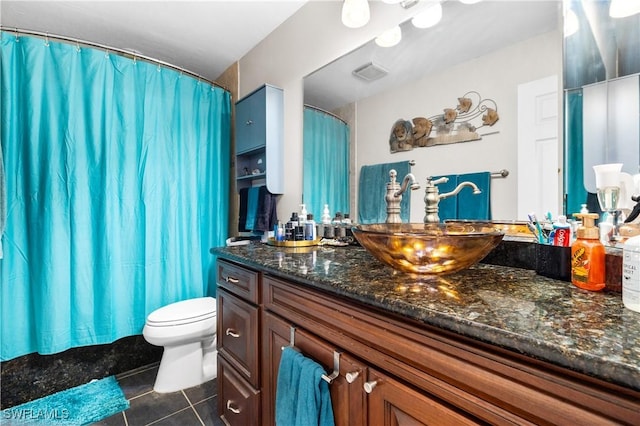 bathroom featuring tile patterned floors, vanity, and toilet