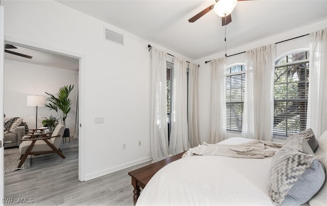 bedroom with ceiling fan and light hardwood / wood-style floors