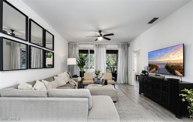 living room with ceiling fan and light hardwood / wood-style floors