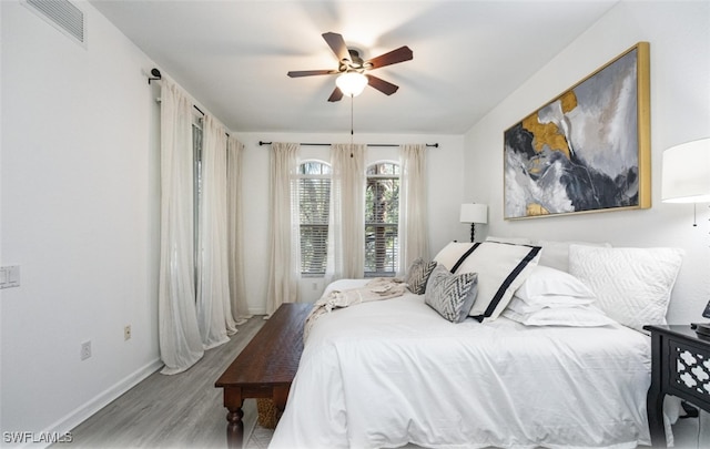 bedroom with hardwood / wood-style floors and ceiling fan