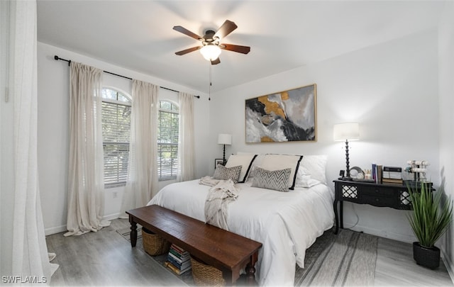 bedroom with ceiling fan and light hardwood / wood-style floors