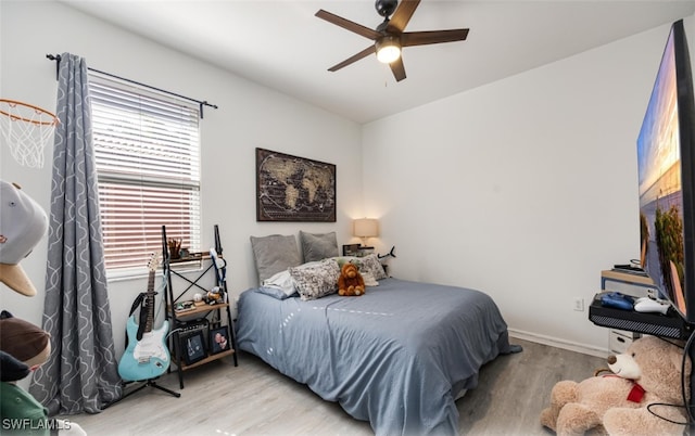 bedroom with ceiling fan and light hardwood / wood-style floors