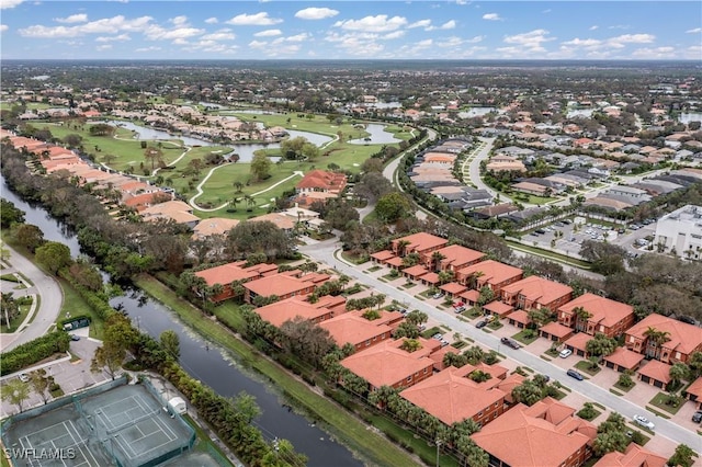 bird's eye view featuring a water view, view of golf course, and a residential view