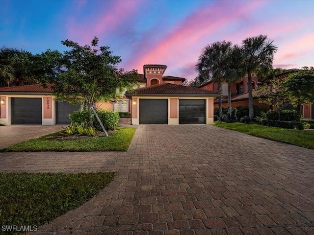 mediterranean / spanish-style home featuring a garage