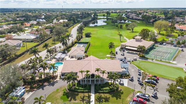 drone / aerial view featuring view of golf course and a water view