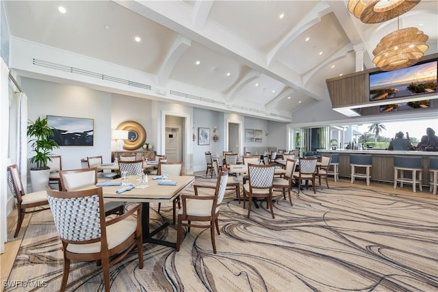 dining space with high vaulted ceiling, beam ceiling, and recessed lighting