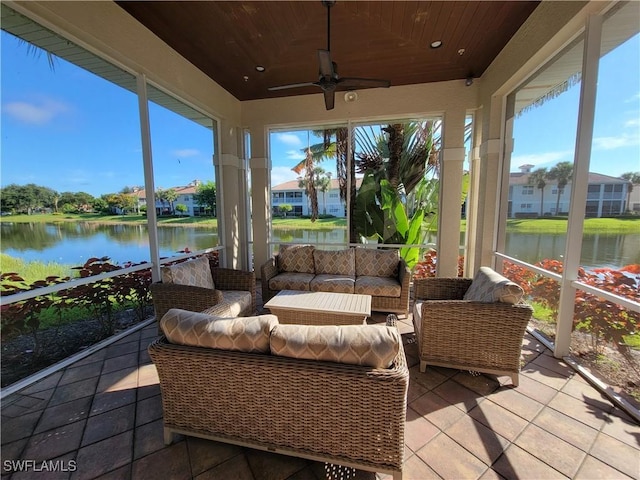 sunroom / solarium with wooden ceiling, ceiling fan, and a water view