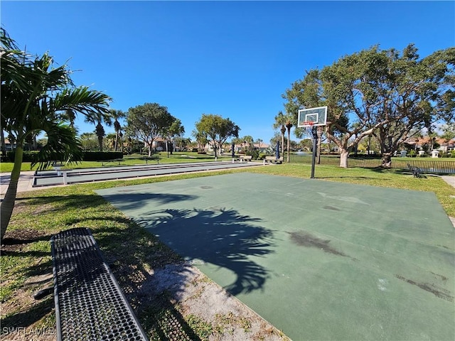 view of basketball court featuring a yard