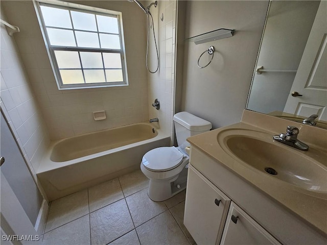 full bathroom with tiled shower / bath combo, vanity, tile patterned floors, and toilet