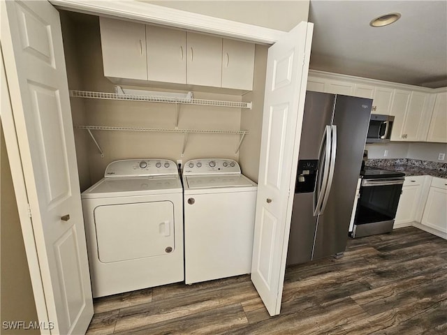 washroom with washing machine and clothes dryer and dark hardwood / wood-style flooring