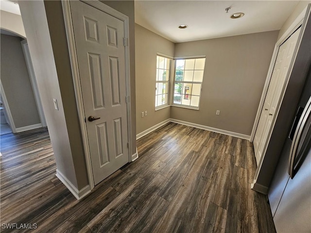 unfurnished bedroom with dark wood-type flooring