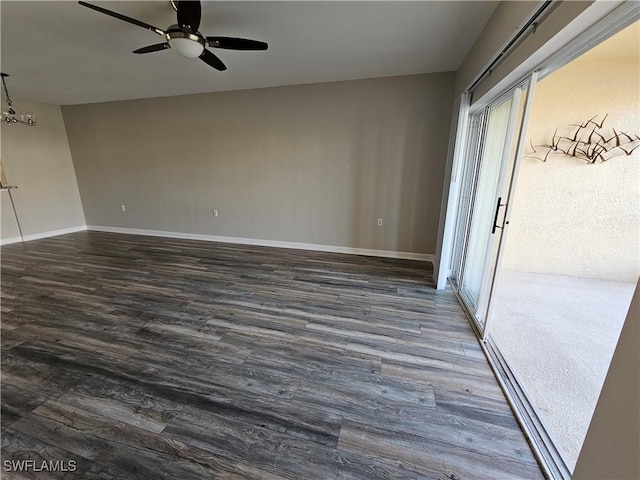 empty room featuring dark wood-type flooring and ceiling fan