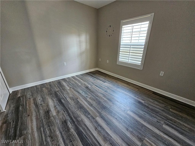 unfurnished room with dark hardwood / wood-style floors