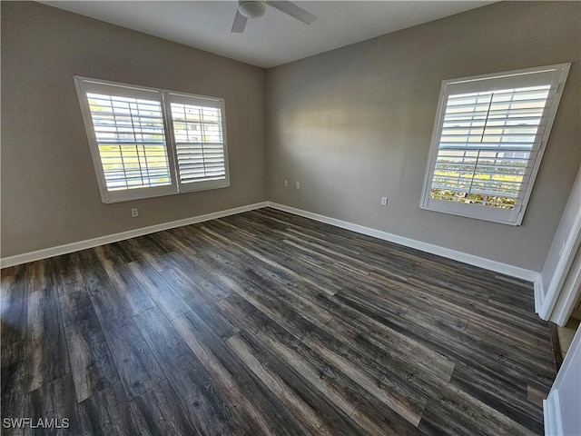 unfurnished room featuring ceiling fan, a healthy amount of sunlight, and dark hardwood / wood-style flooring