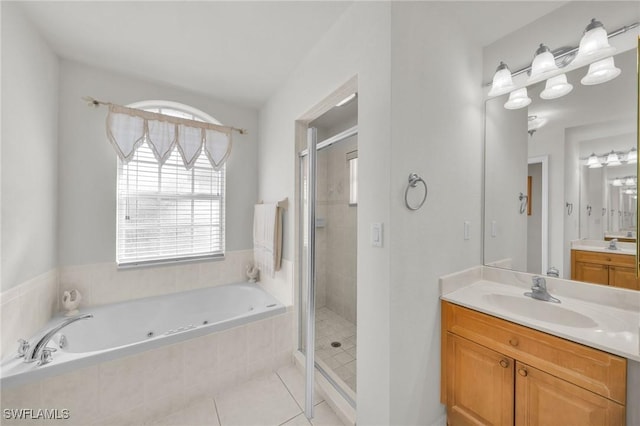 bathroom with tile patterned flooring, vanity, and shower with separate bathtub