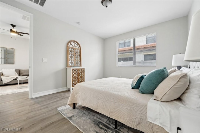 bedroom featuring ceiling fan and hardwood / wood-style flooring