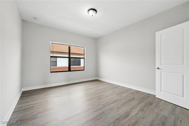 empty room with hardwood / wood-style floors