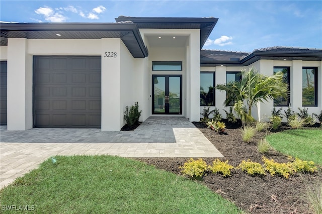 entrance to property with a garage and french doors