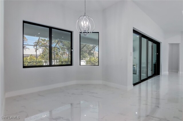 unfurnished room with an inviting chandelier