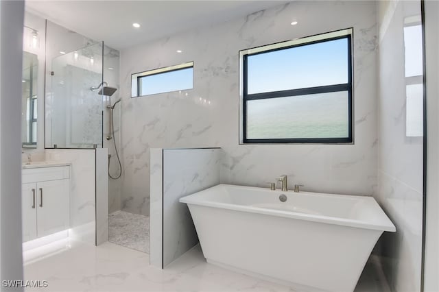 bathroom with vanity and separate shower and tub