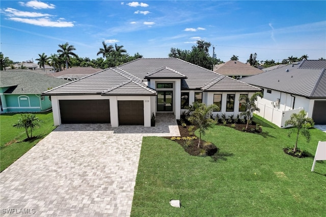 view of front of house with a garage and a front lawn