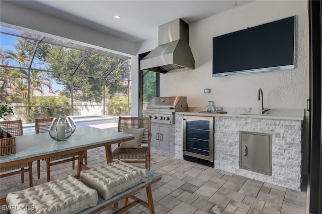 view of patio / terrace with sink, wine cooler, area for grilling, a lanai, and a grill