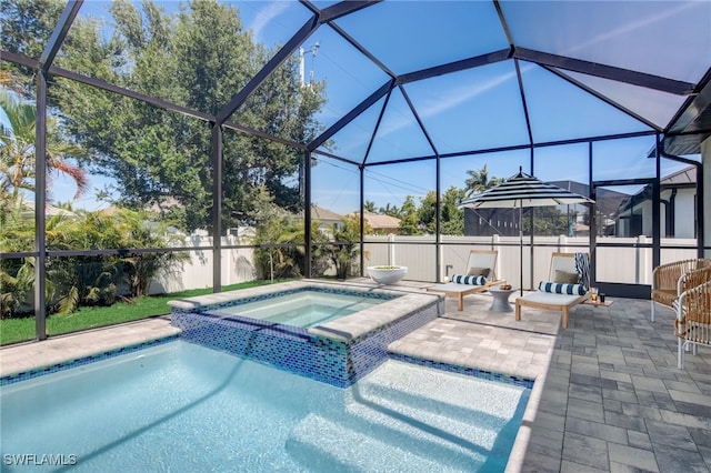 view of swimming pool with a lanai, a patio area, and an in ground hot tub