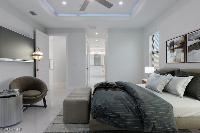 bedroom with a raised ceiling and ceiling fan