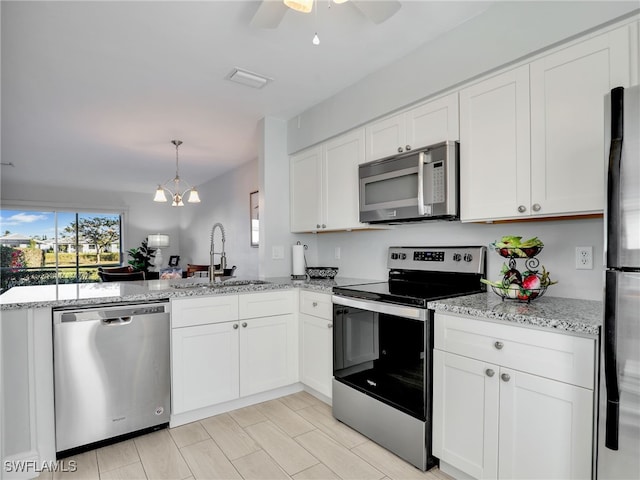 kitchen featuring sink, white cabinets, and appliances with stainless steel finishes