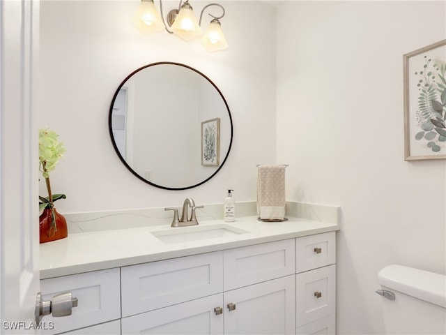 bathroom featuring vanity and toilet