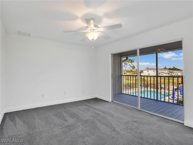 carpeted spare room with ceiling fan