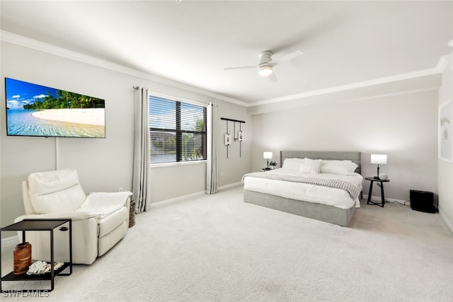 carpeted bedroom featuring ceiling fan and crown molding