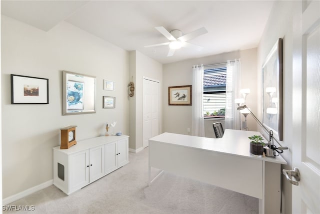 home office featuring light carpet and ceiling fan