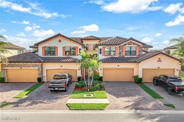 mediterranean / spanish home featuring a garage