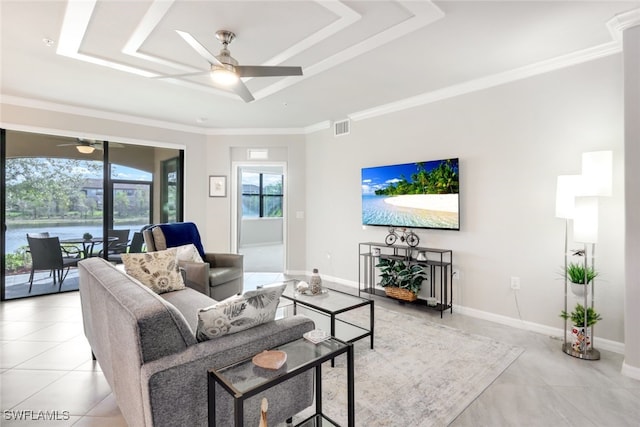 tiled living room with a raised ceiling, ceiling fan, and crown molding