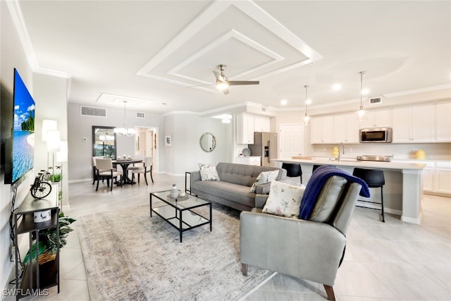 living room with ceiling fan, sink, light tile patterned flooring, and ornamental molding